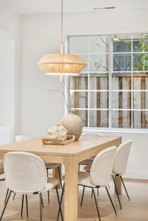 a living room with furniture a large window and table