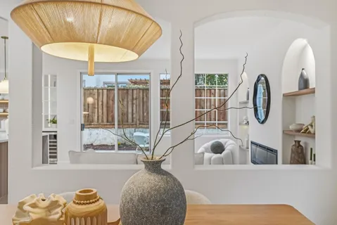 a living room with furniture potted plant and bathroom