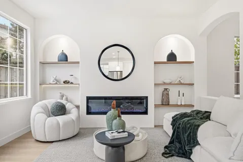 a kitchen with stainless steel appliances granite countertop a sink a center island a stove and a wooden floor