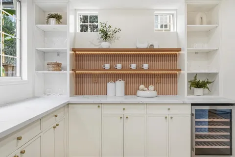 a bedroom with a bed and painting on the wall