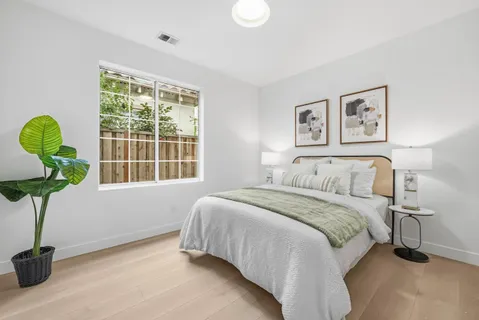 a spacious bathroom with double vanity a mirror and shower
