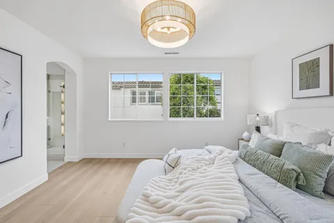a bedroom with a bed and a chandelier