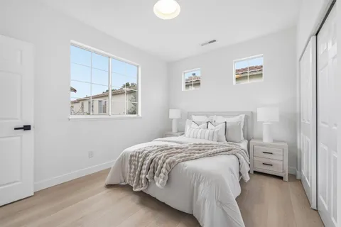 a front view of a house with a lots of potted plants