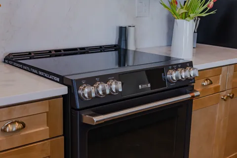 a kitchen with stainless steel appliances a sink a stove and cabinets
