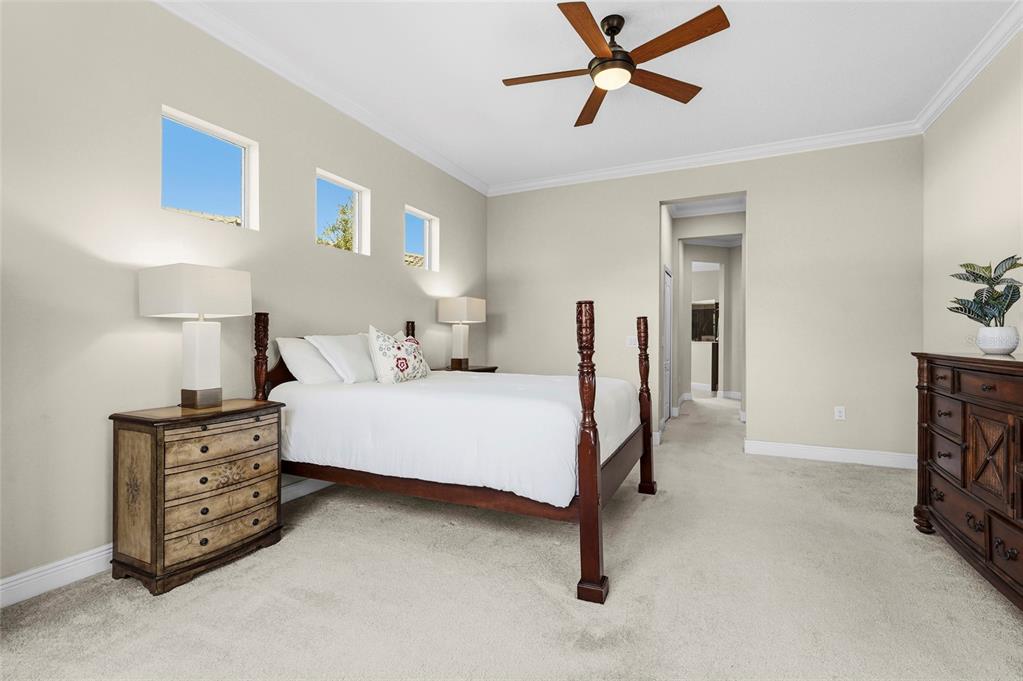 357 Marsh Creek Road Venice, FL 34292 - Photo 27 of 70 a bedroom with a bed and a ceiling fan