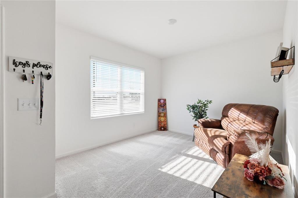 628 Knightsbridge Lane Winder, GA 30680 - Photo 11 of 42 a living room with furniture and a window