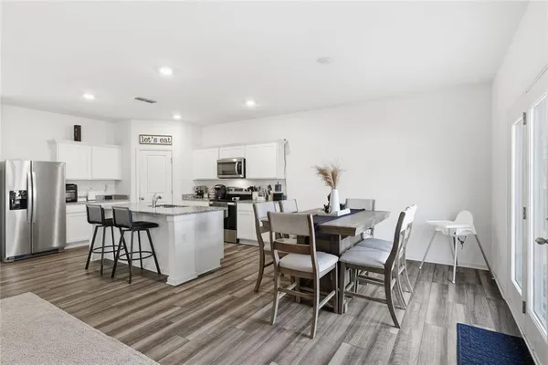 a view of a dining room with furniture and wooden floor