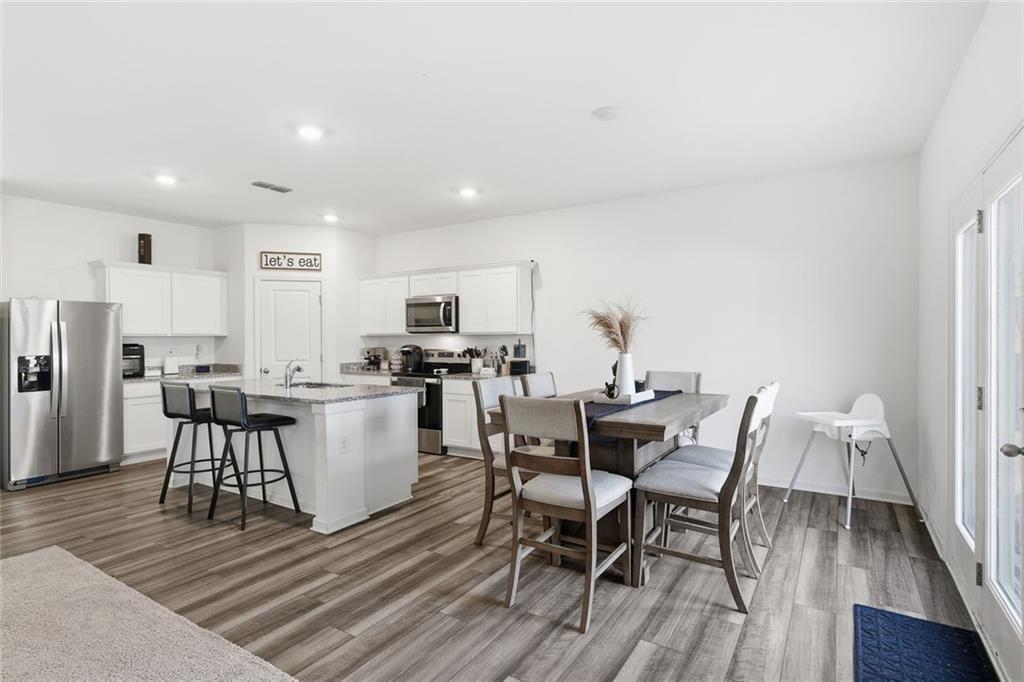 628 Knightsbridge Lane Winder, GA 30680 - Photo 14 of 42 a view of a dining room with furniture and wooden floor
