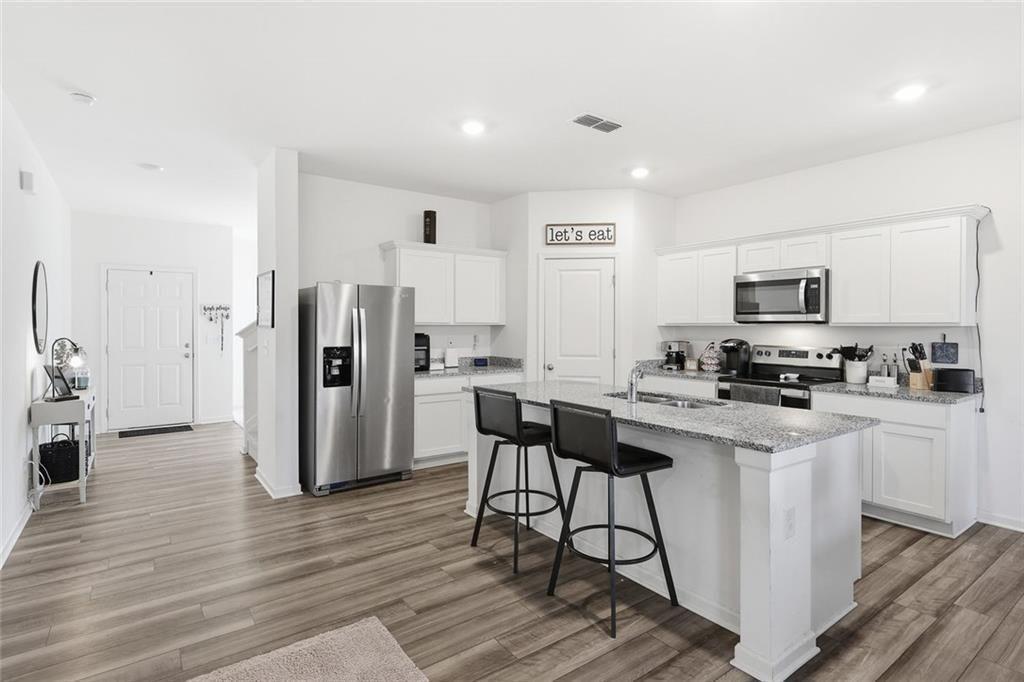 628 Knightsbridge Lane Winder, GA 30680 - Photo 15 of 42 a kitchen with stainless steel appliances a stove refrigerator sink and microwave