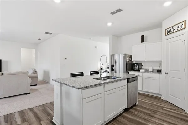 a kitchen with stainless steel appliances granite countertop a sink stove and refrigerator