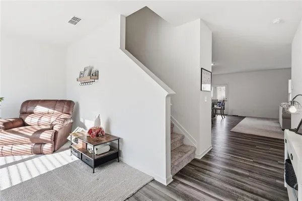 a bedroom with furniture and a wooden floor