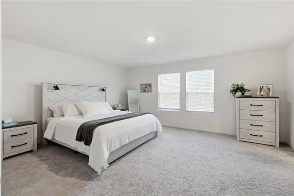 a bed room with a bed and a window