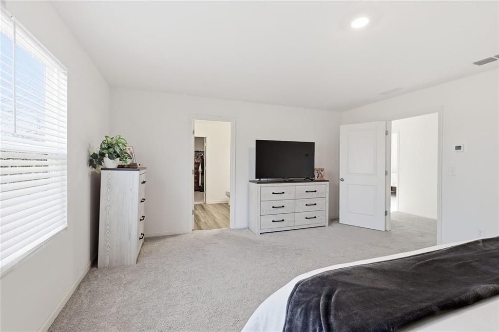 628 Knightsbridge Lane Winder, GA 30680 - Photo 20 of 42 a bedroom with a bed and flat screen tv