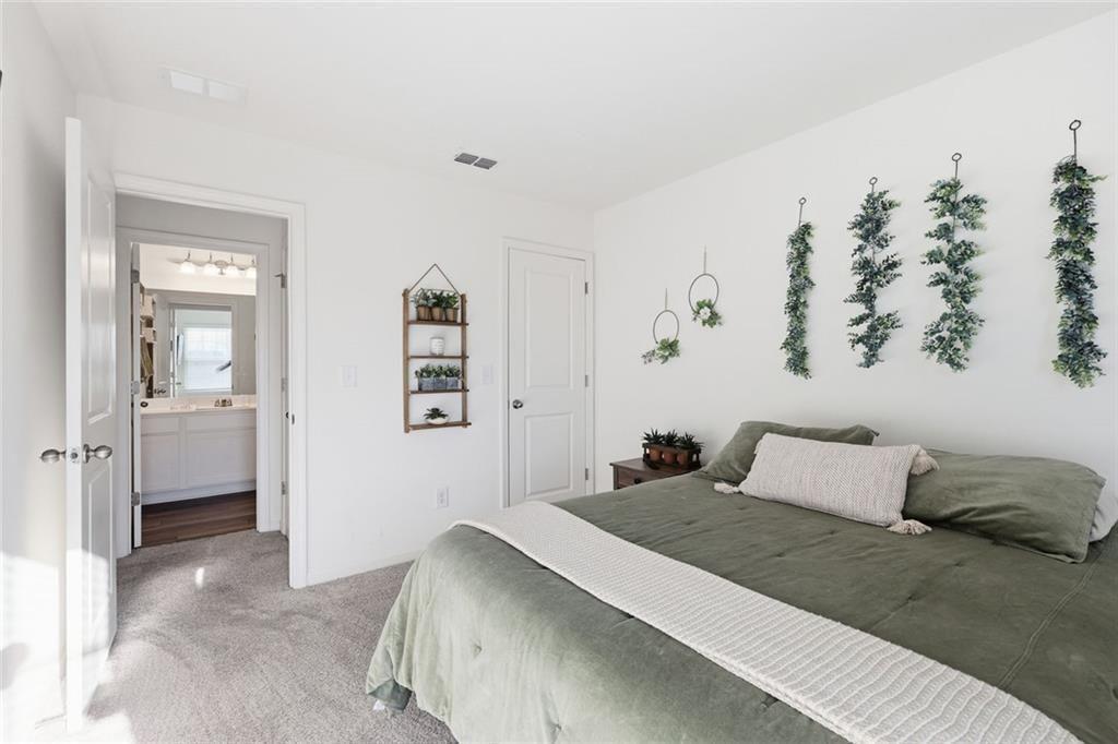 628 Knightsbridge Lane Winder, GA 30680 - Photo 24 of 42 a bedroom with a bed and a couch