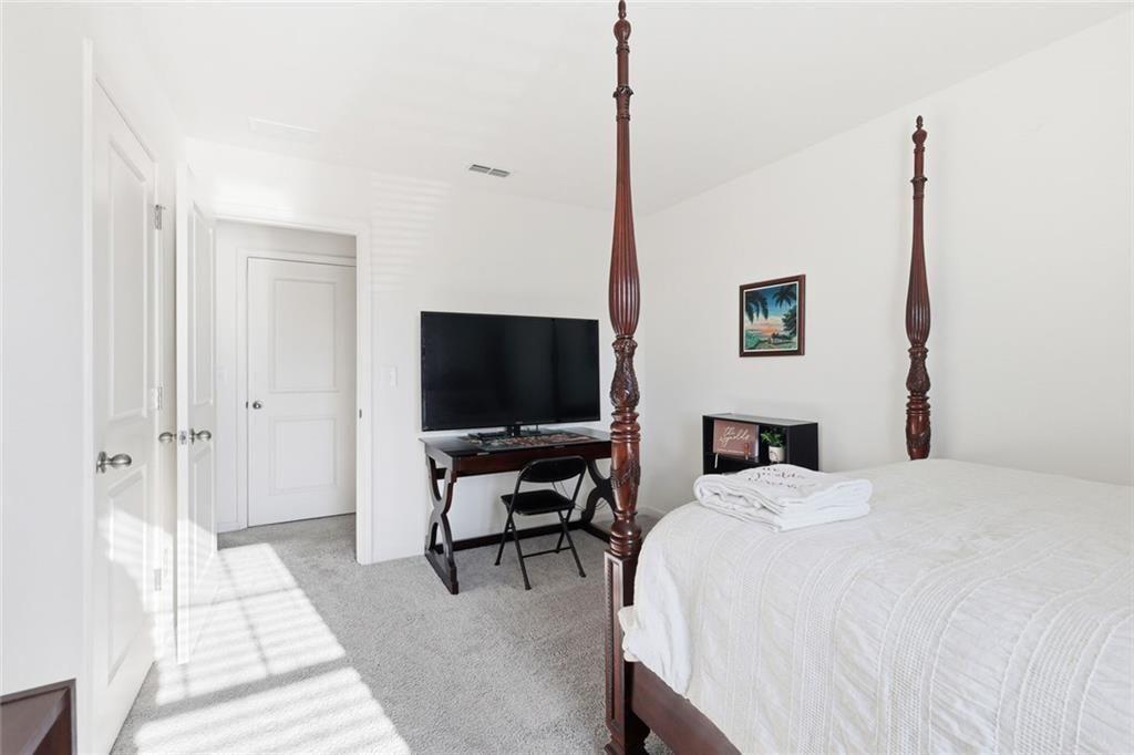 628 Knightsbridge Lane Winder, GA 30680 - Photo 25 of 42 a bedroom with a bed and a flat screen tv