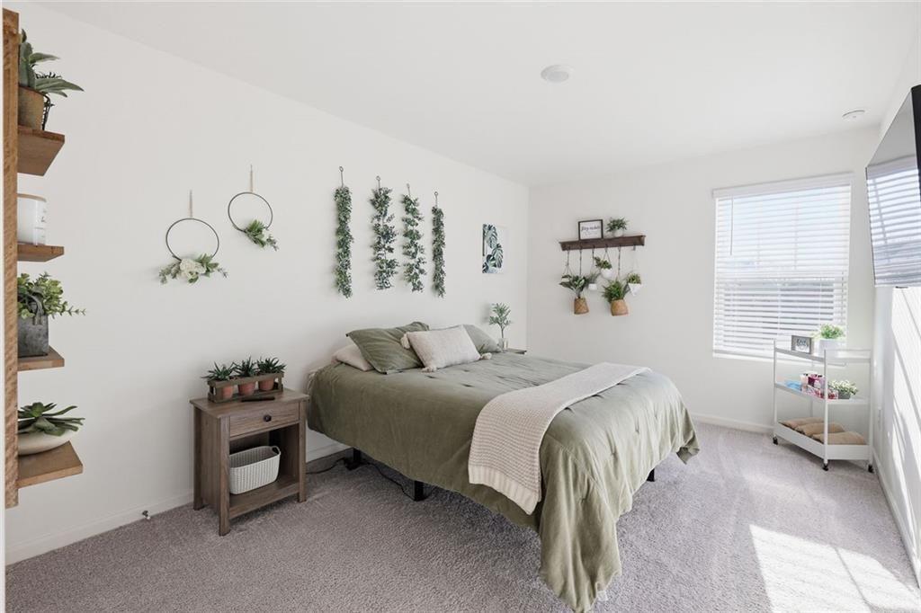 628 Knightsbridge Lane Winder, GA 30680 - Photo 27 of 42 a bedroom with a bed and a table in it