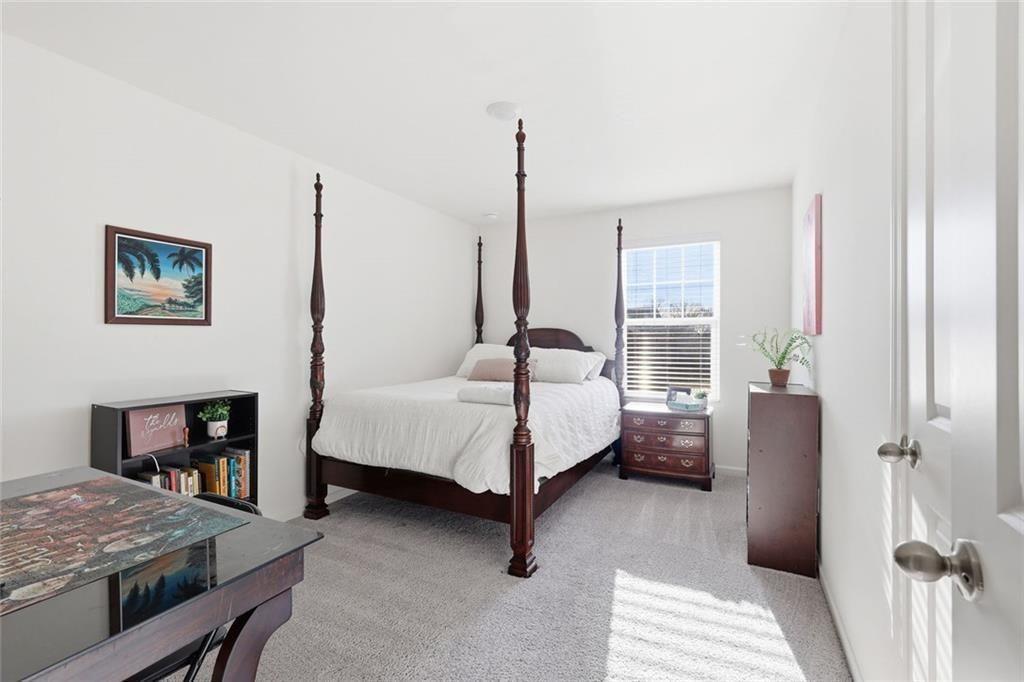 628 Knightsbridge Lane Winder, GA 30680 - Photo 28 of 42 a bed room with a bed and a couch