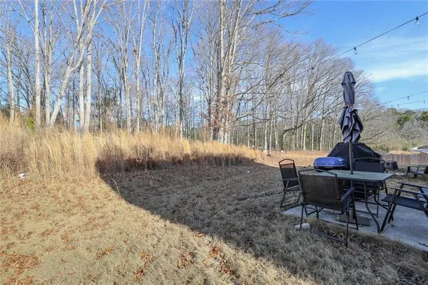 a view of a backyard with sitting area
