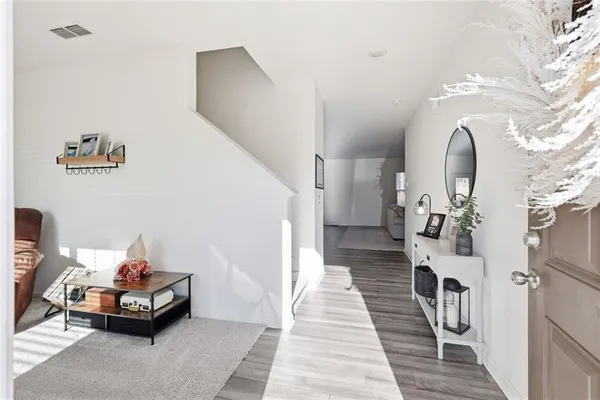 a view of a livingroom with furniture and stairs