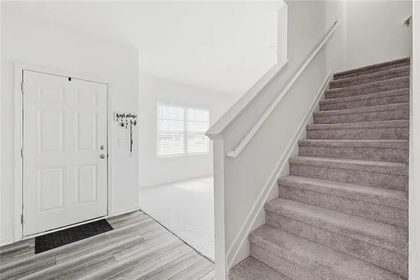 a view of entryway and hall with wooden floor