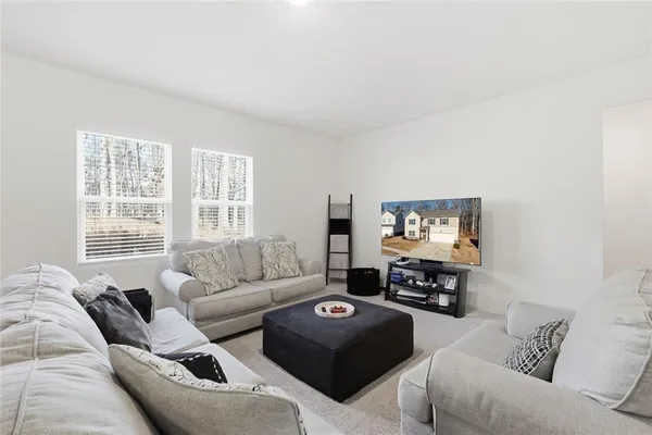 a living room with furniture and a flat screen tv