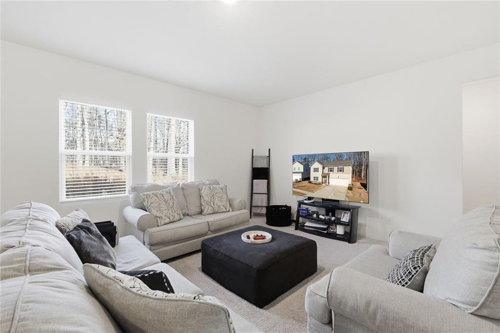 628 Knightsbridge Lane Winder, GA 30680 - Photo 9 of 42 a living room with furniture and a flat screen tv