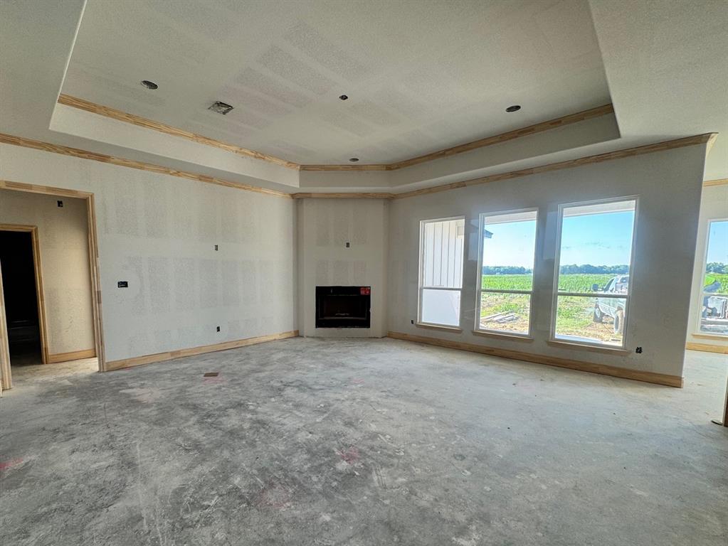 173 Willow Branch Road McGregor, TX 76657 - Photo 5 of 18 a view of an empty room with a fireplace and a window