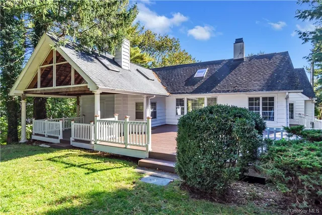 a front view of a house with a yard table and chairs