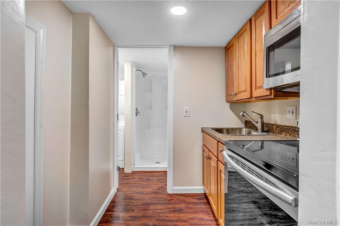 1058 Wilmot Road Scarsdale, NY 10583 - Photo 16 of 19 a kitchen with a sink and a refrigerator