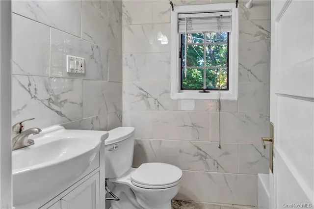 a bathroom with a sink a toilet and a shower