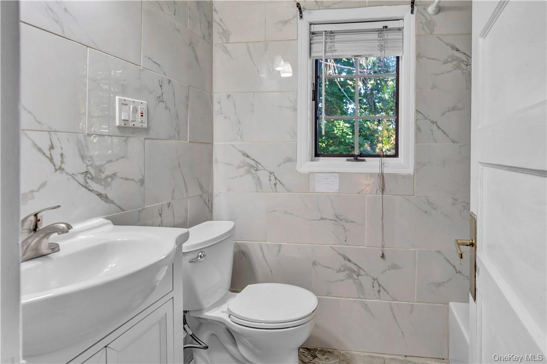 1058 Wilmot Road Scarsdale, NY 10583 - Photo 8 of 19 a bathroom with a sink a toilet and a shower