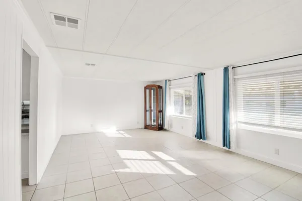 a view of a big room with windows and closet