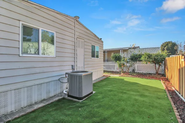 a view of a backyard with plants and a patio