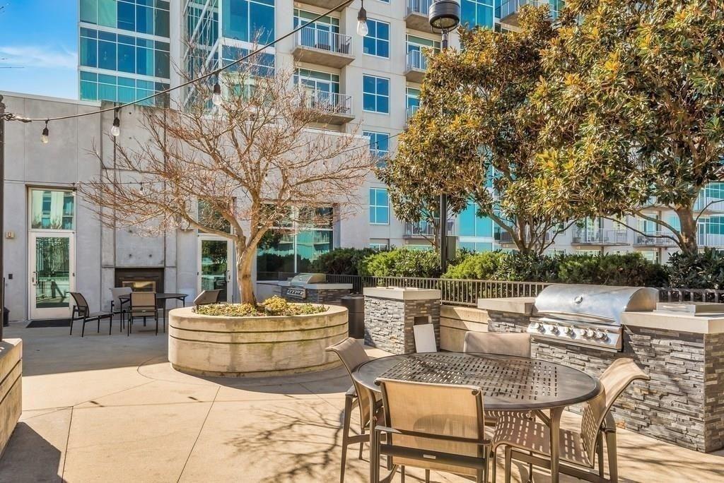250 Pharr Road Northeast, Unit 601 Atlanta, GA 30305 - Photo 25 of 34 a view of a patio with couches table and chairs and potted plants