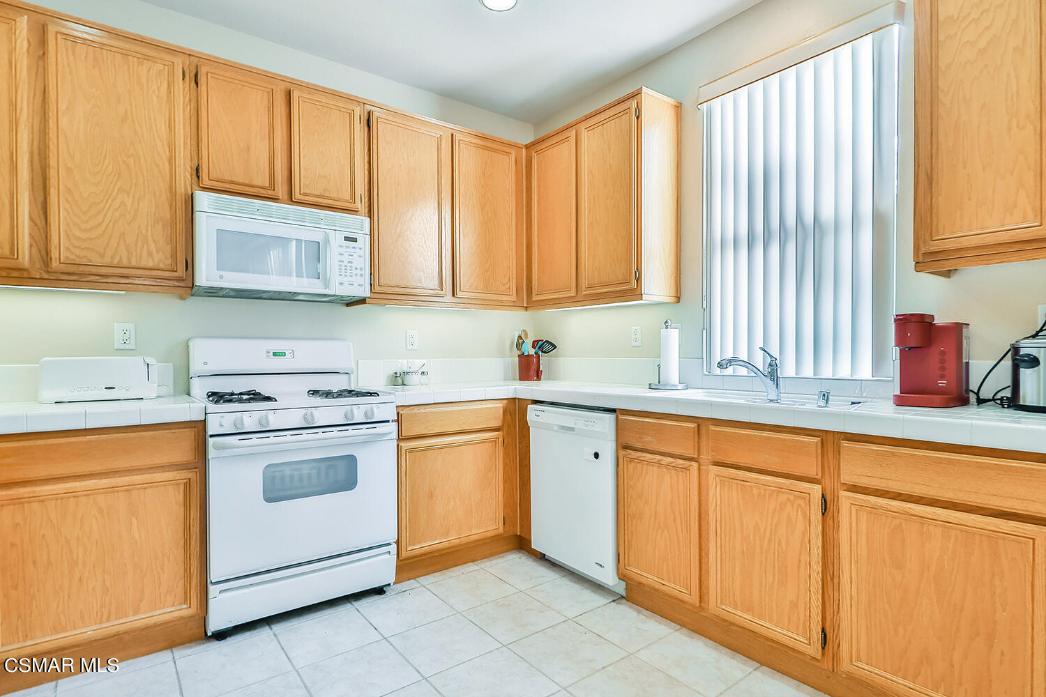 2317 Shakespeare Drive, Unit 9 Oxnard, CA 93033 - Photo 6 of 16 a kitchen with granite countertop cabinets sink and appliances