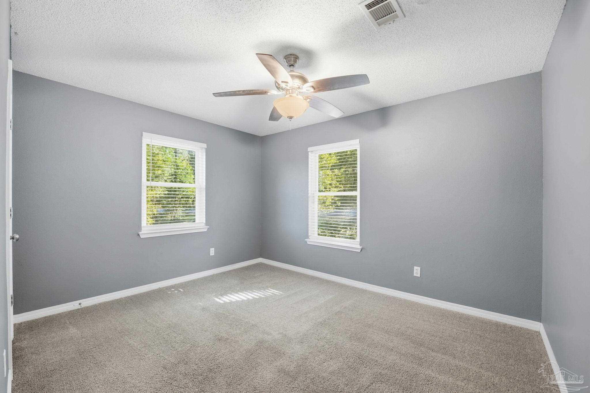 2162 Old Chemstrand Road Cantonment, FL 32533 - Photo 11 of 24 an empty room with windows and fan