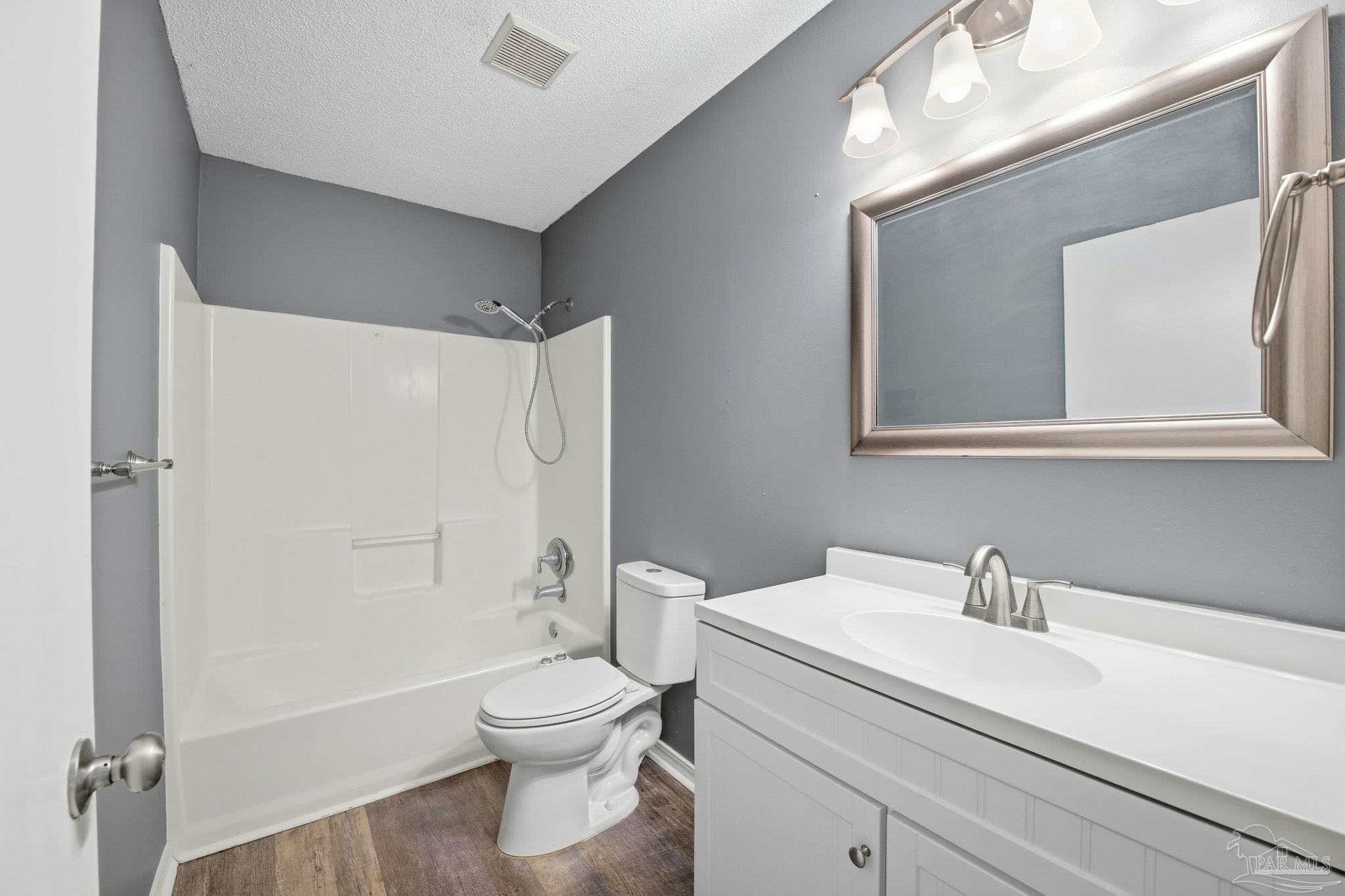 2162 Old Chemstrand Road Cantonment, FL 32533 - Photo 13 of 24 a bathroom with a sink a toilet and shower