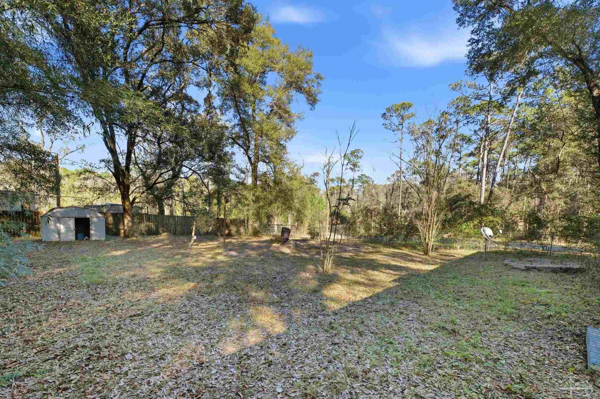 2162 Old Chemstrand Road Cantonment, FL 32533 - Photo 19 of 24 a view of a yard with a tree
