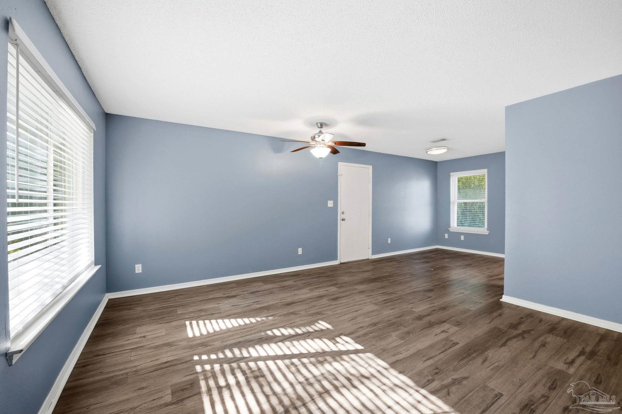 2162 Old Chemstrand Road Cantonment, FL 32533 - Photo 2 of 24 a view of an empty room with wooden floor and a window
