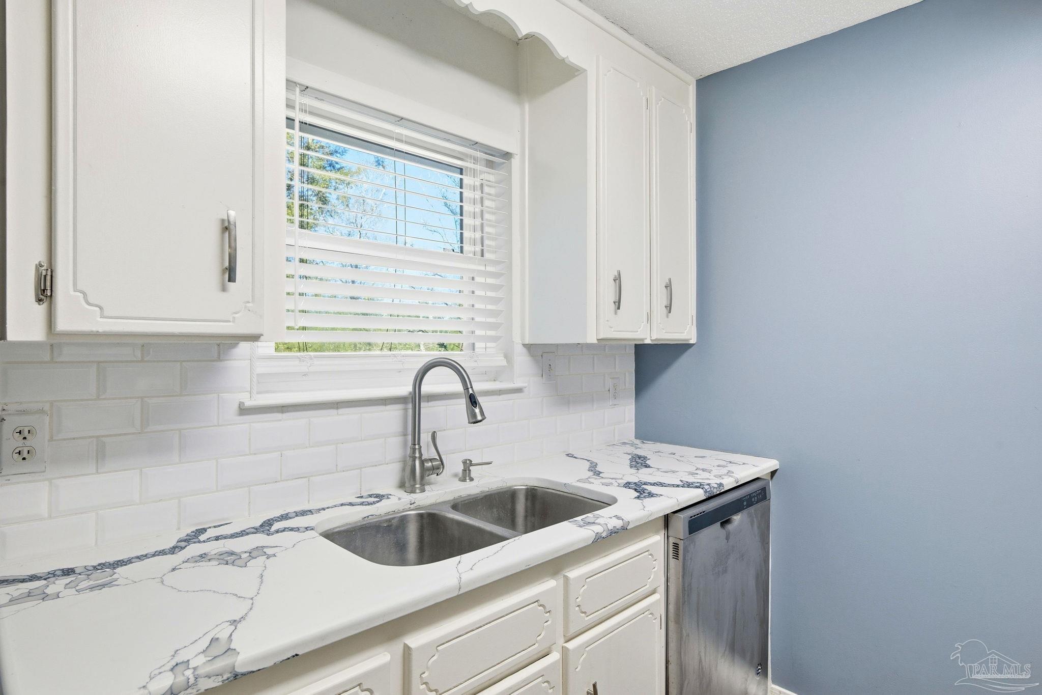 2162 Old Chemstrand Road Cantonment, FL 32533 - Photo 7 of 24 a kitchen with a sink and cabinets