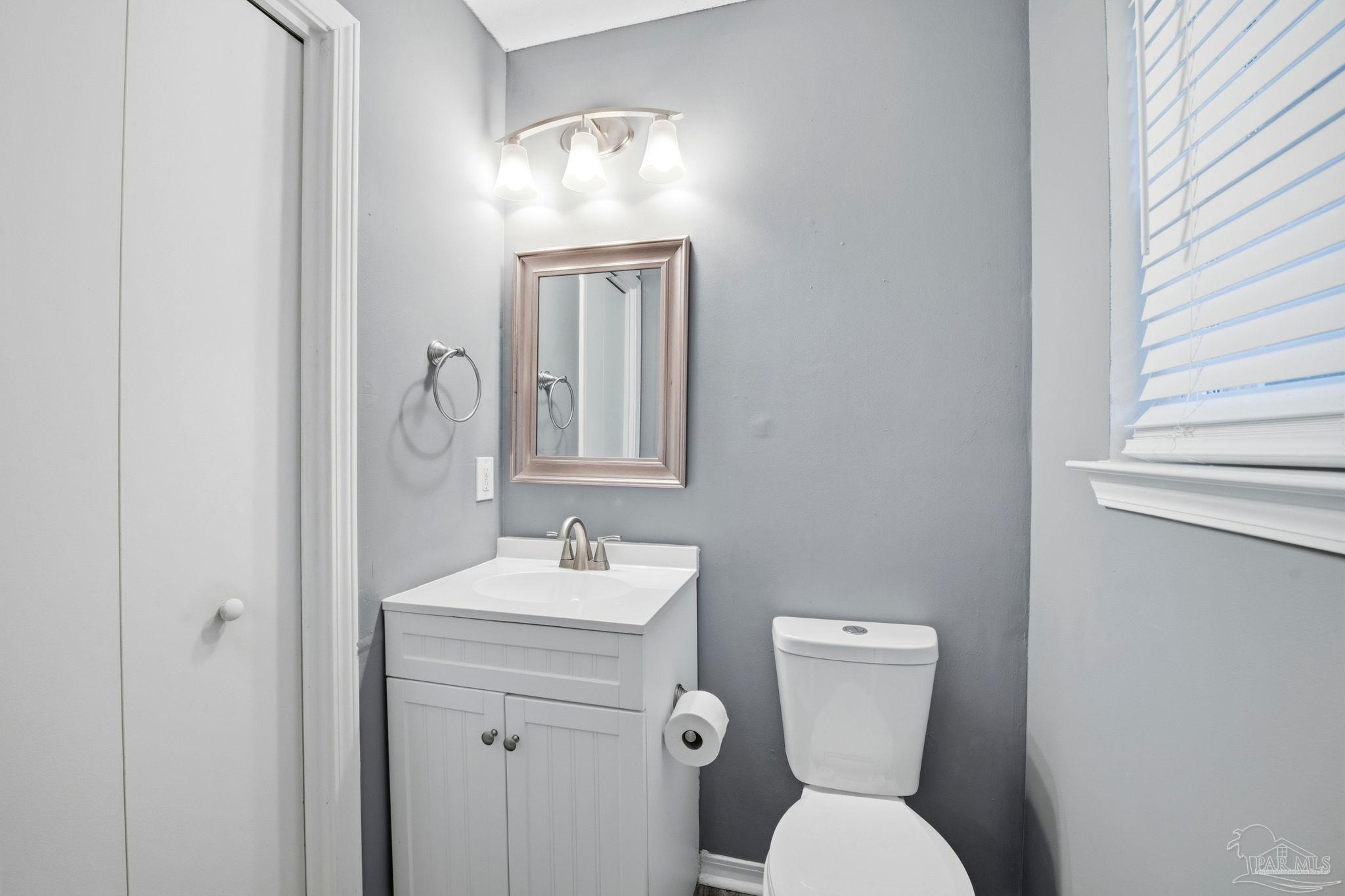 2162 Old Chemstrand Road Cantonment, FL 32533 - Photo 10 of 24 a bathroom with a toilet sink and mirror