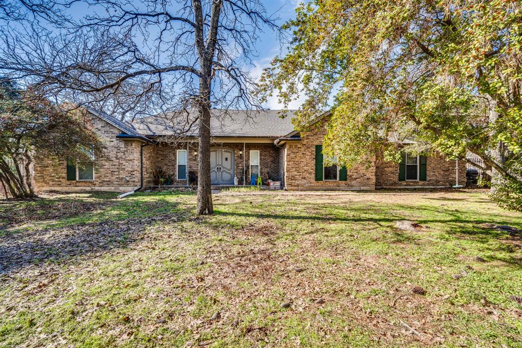 140 Cedarcrest Lane Double Oak, TX 75077 - Photo 1 of 1 Back of house featuring a lawn
