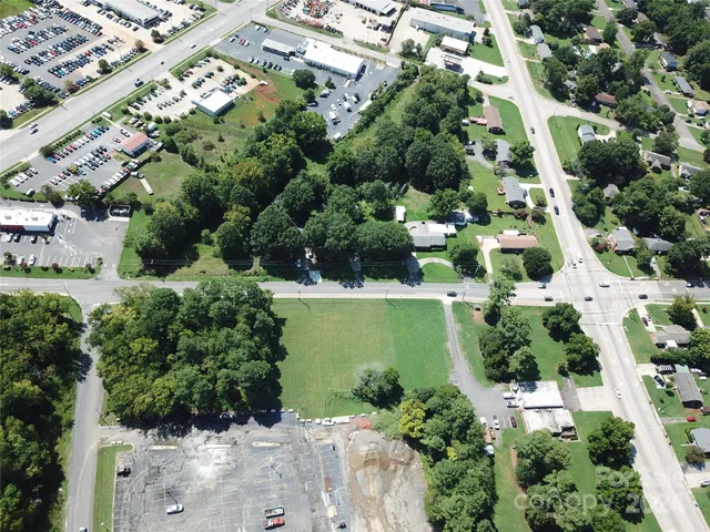 an aerial view of a residential houses with outdoor space and street view