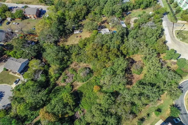 an aerial view of residential house with outdoor space and trees all around