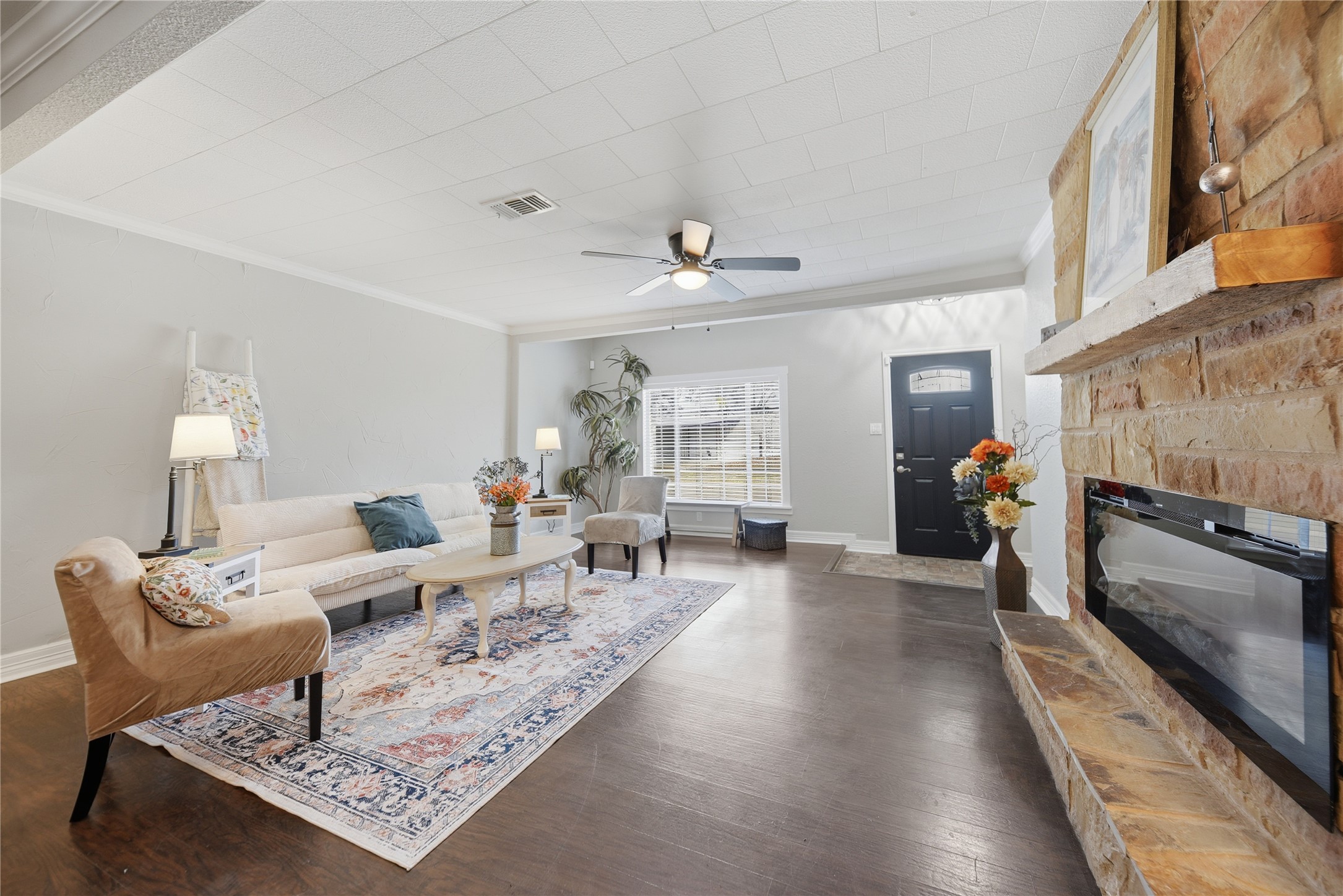 1702 Rampart Street Columbus, TX 78934 - Photo 27 of 38 Living room with a fireplace, ornamental molding, dark wood finished floors, and a ceiling fan