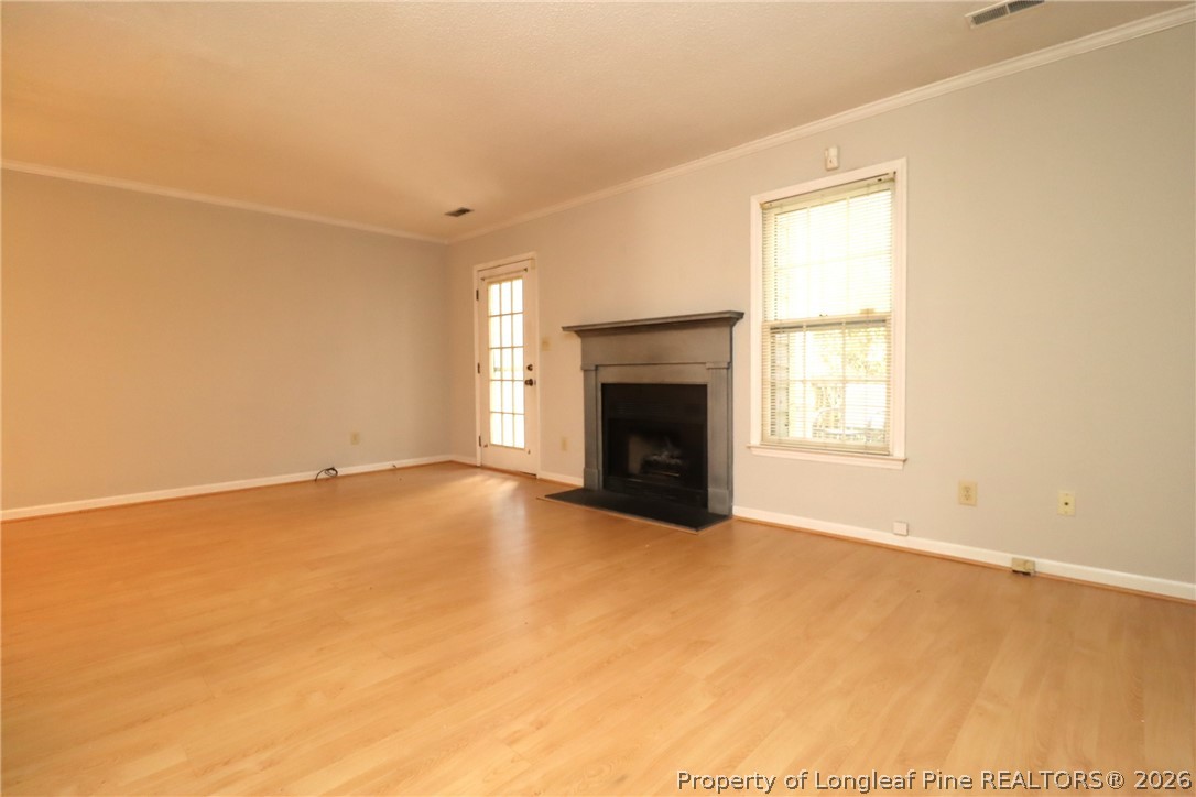 7424 Penny Hill Lane Raleigh, NC 27615 - Photo 16 of 30 an empty room with windows and fireplace