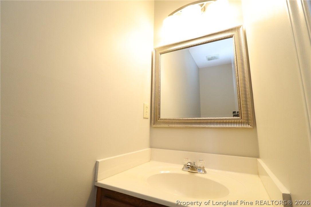 7424 Penny Hill Lane Raleigh, NC 27615 - Photo 19 of 30 a bathroom with a sink and a mirror