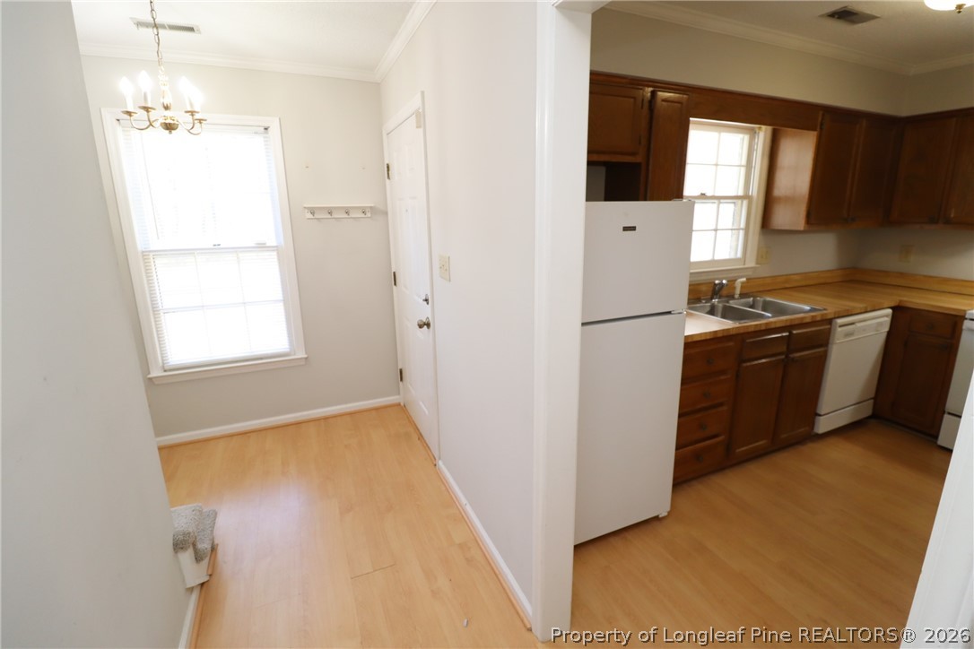 7424 Penny Hill Lane Raleigh, NC 27615 - Photo 21 of 30 a kitchen with a refrigerator a stove top oven a sink and dishwasher