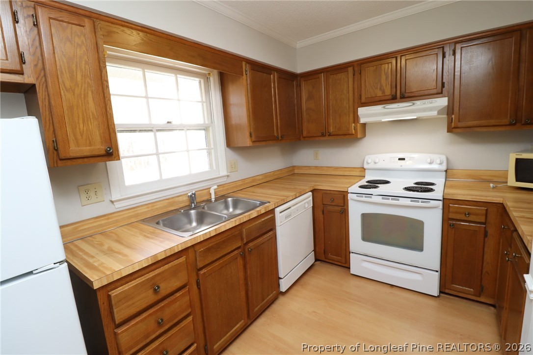 7424 Penny Hill Lane Raleigh, NC 27615 - Photo 4 of 30 a kitchen with a sink stove top oven and cabinets