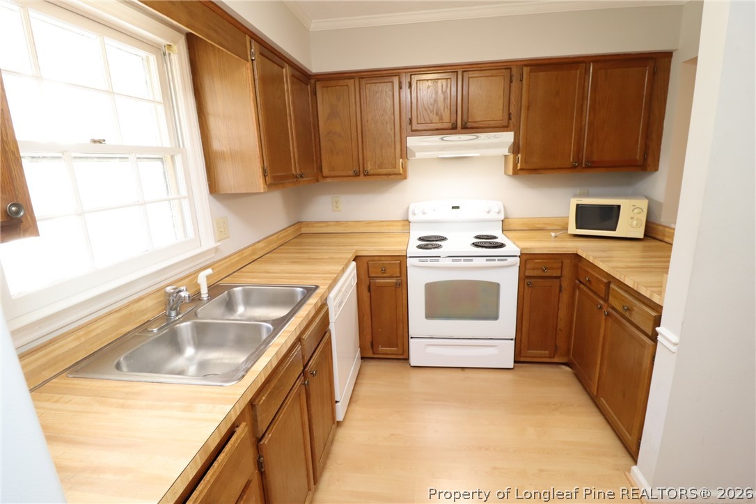 7424 Penny Hill Lane Raleigh, NC 27615 - Photo 5 of 30 a kitchen with a stove sink and cabinets